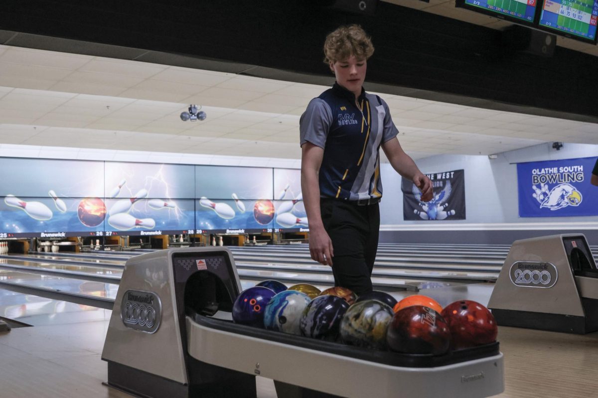 While walking up the lane, sophomore Devin Leiker scans for a bowling ball. 