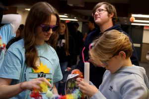 Junior Avery Clement and freshman Asher Clement try on photo props before taking a group photo Friday, Jan. 31