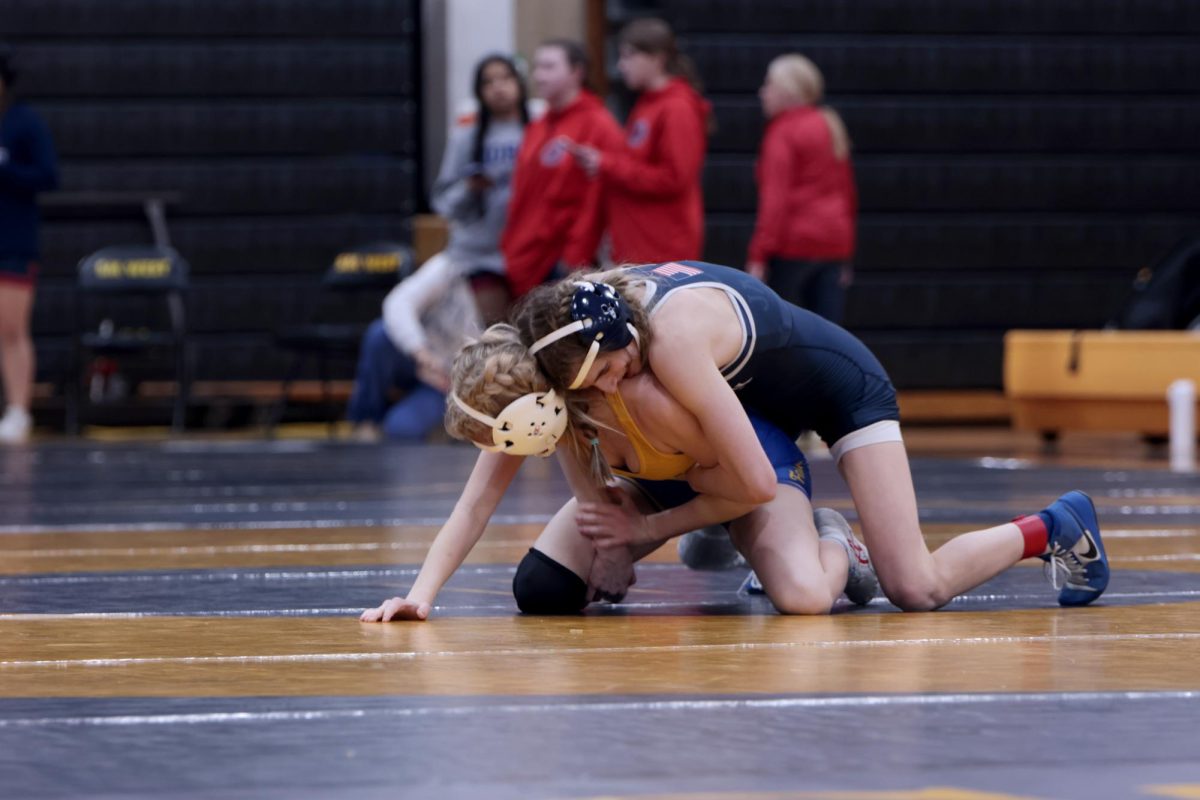 Taking down her opponent, junior Finley Rose pins her on the ground. 
