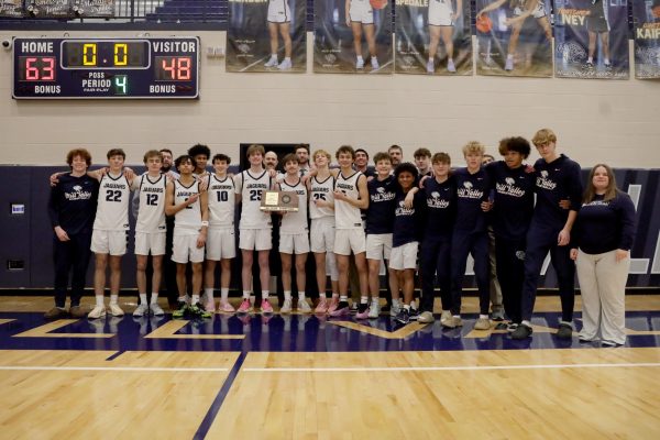 Post game, boys basketball poses with their substate trophy