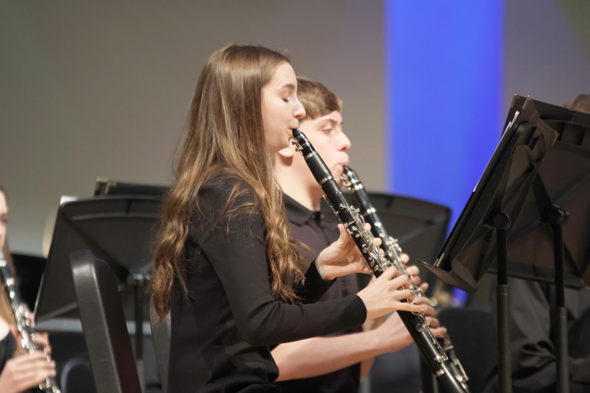 Sophomore Molly Gilmore closes her eyes to remain concentrated during the song