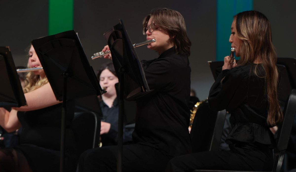 As one,freshman Nik Ayers and sophomore Maddie Vongphrachanh play their instruments together. 
