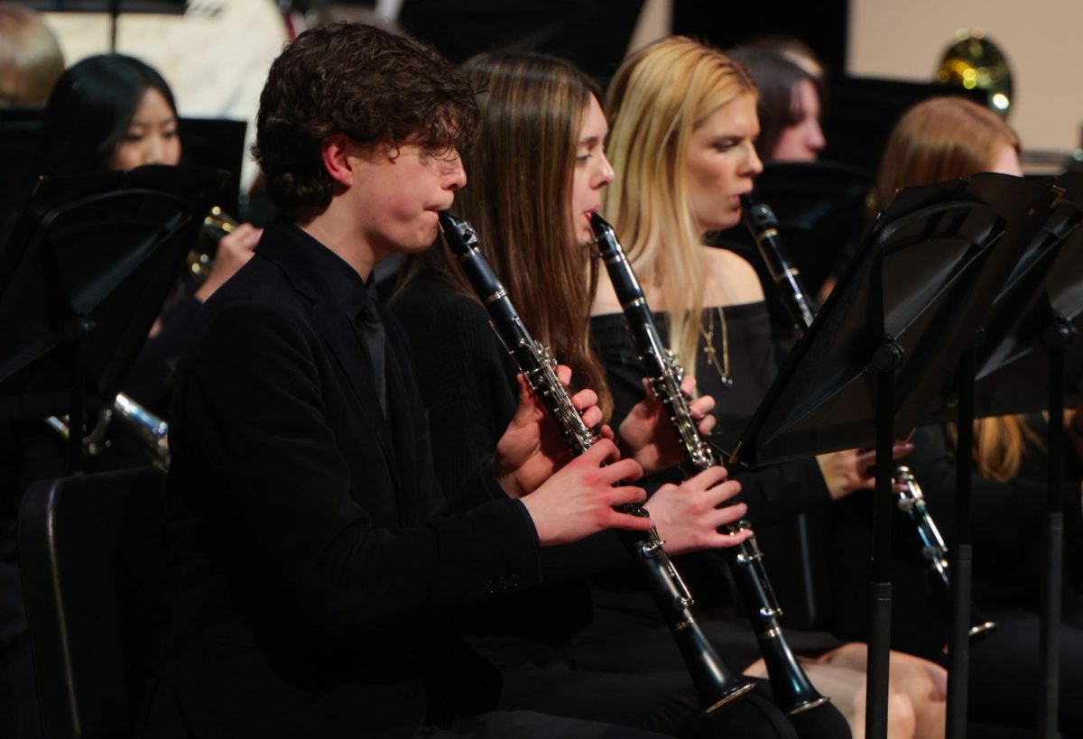 All together, seniors Kai McGarry, Halle Nelson, Abigail Gafney look towards their music.
