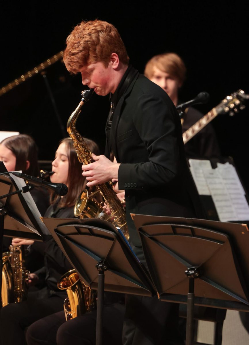 Concentrating, senior Brayden Evans plays a saxophone solo during one of the jazz numbers. 
