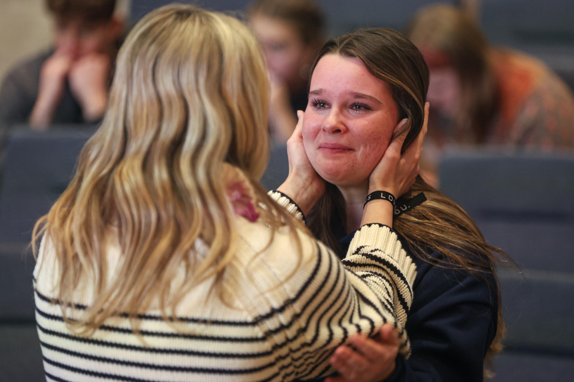 With teary eyes, junior Bianca Pepe cries after praying with junior Bella McPeake.