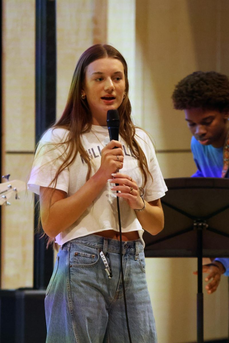 Standing up on stage, senior Seville Skinner talks to the crowd about Christ.