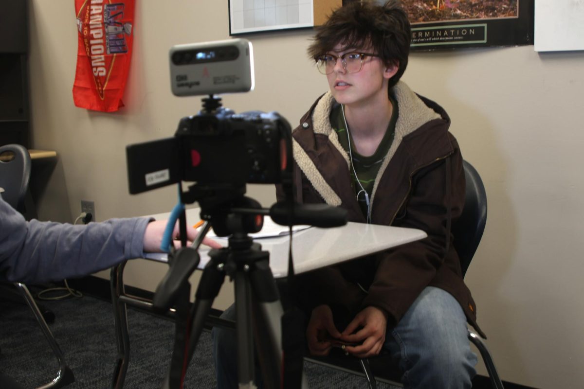 Junior Nick Baird listens as he is given instructions about how to say his lines. 