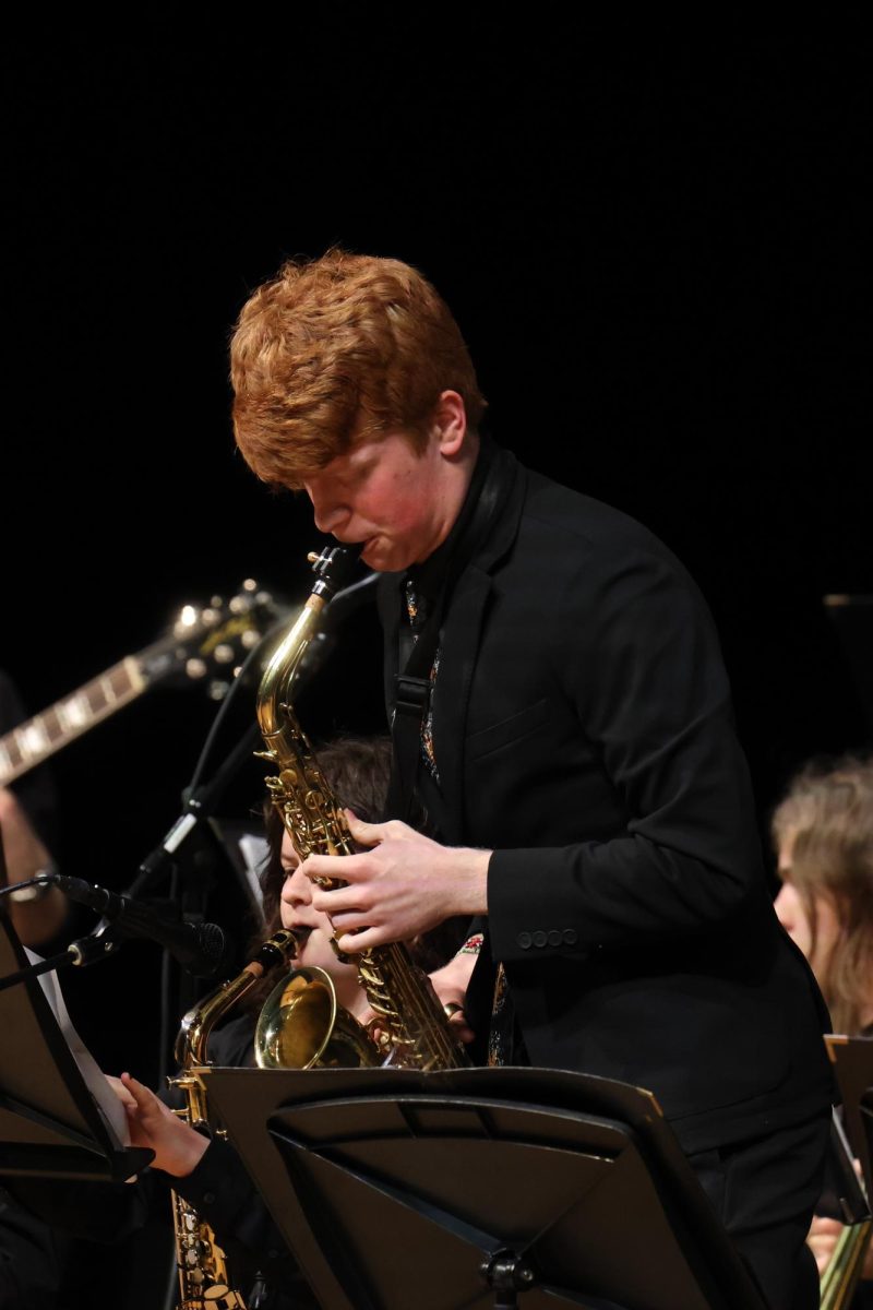 Instrument to the mic, senior Brayden Evans does a solo in front of the audience.