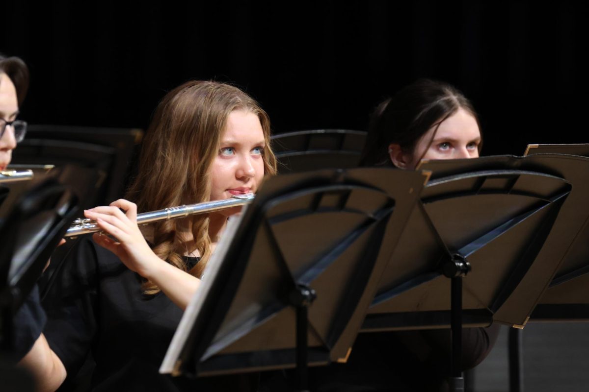 Looking up, junior Taylor Goodwin looks at the conductor while performing.