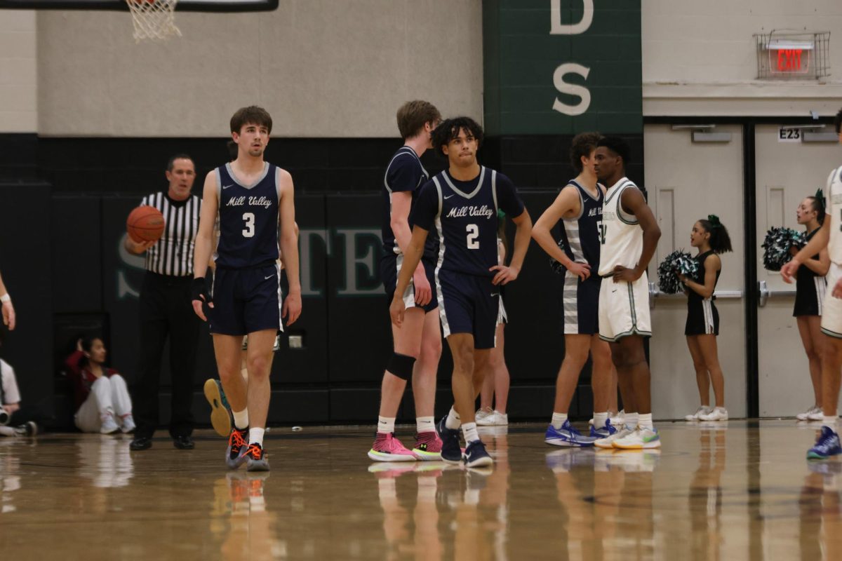 Senior Thatcher Ivey and junior Jakhai Carter walk with each other back to mid-court