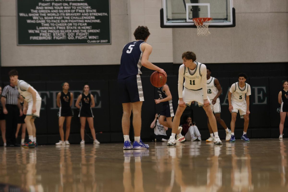 Junior Reece Riedel waits for the play to develop while letting the clock run out