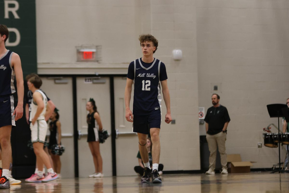 Sophomore Hayes Henderson looks to his coach for a play after the free-throw