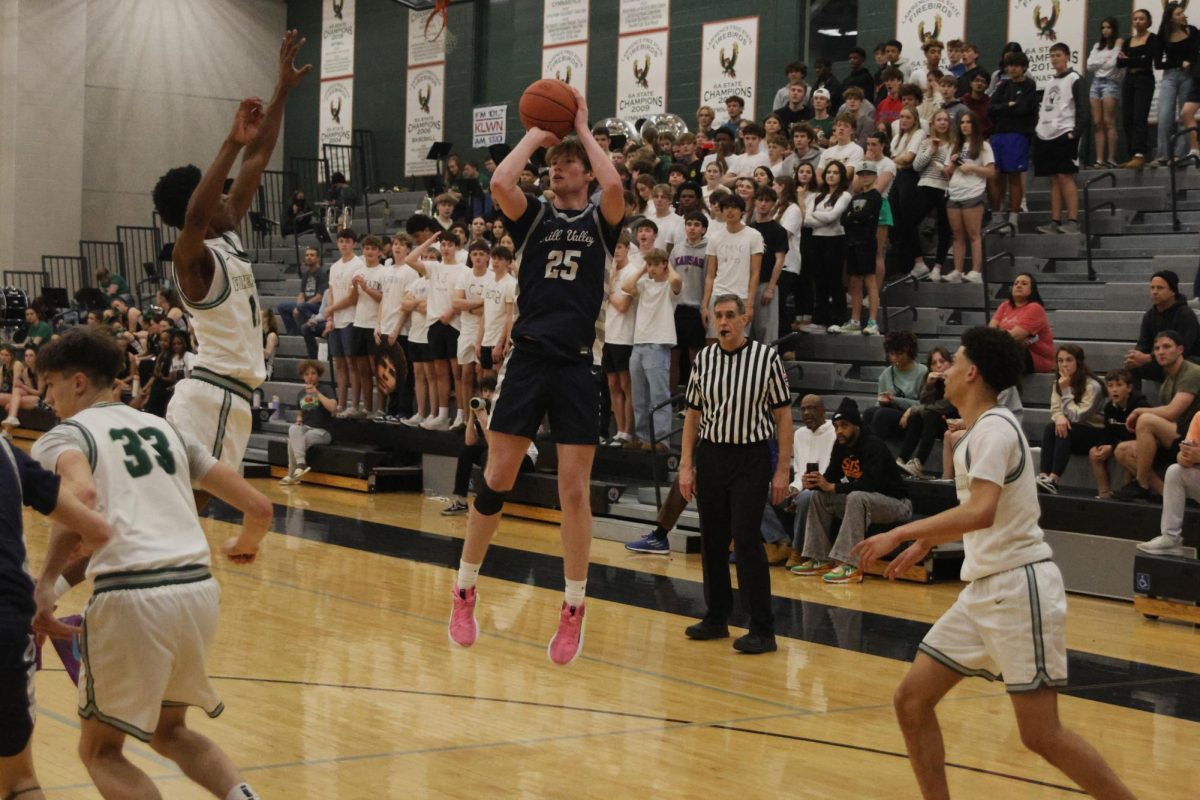 Senior Carter Kaifes shoots a 3 as the Free State student section watches