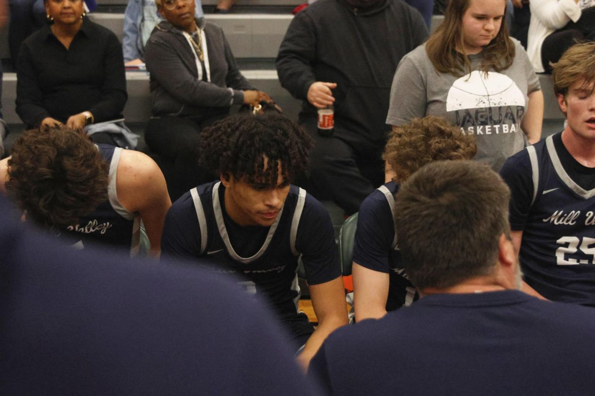 Junior Jakhai Carter listens intently to his coach during a time out