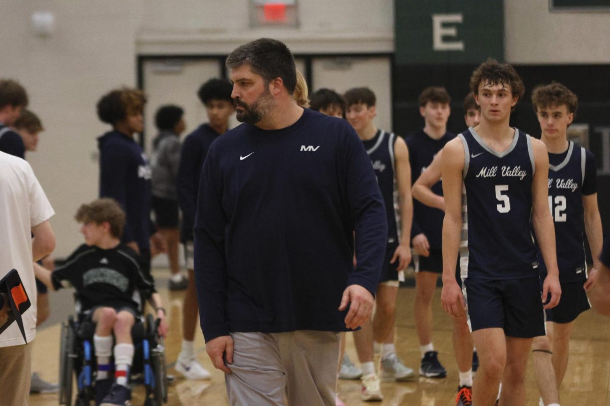 Coach Kurtis Bangle walks off the court victorious in the last regular season game of the year