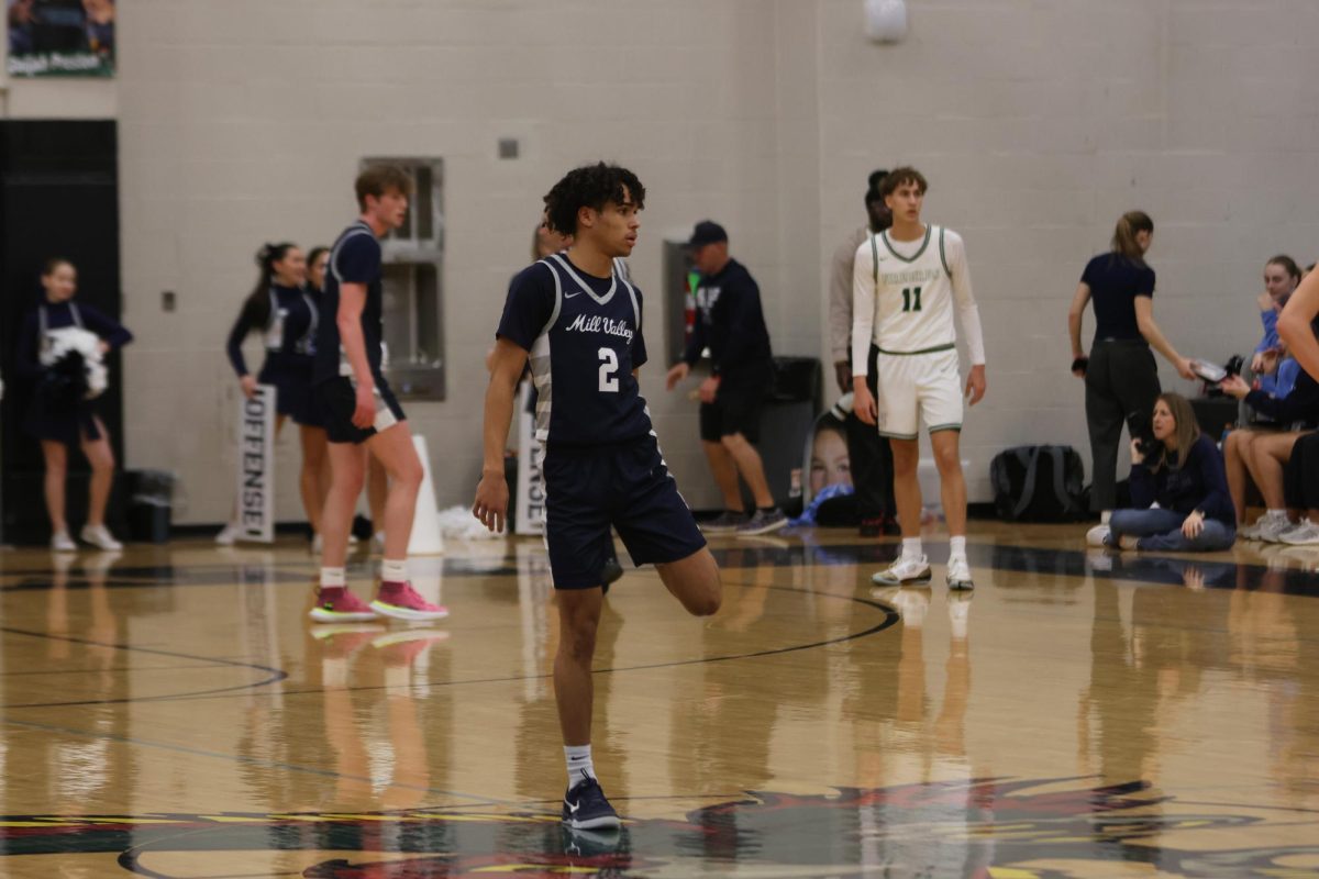 Junior Jakhai Carter wipes off his shoes as the opponent comes up the court