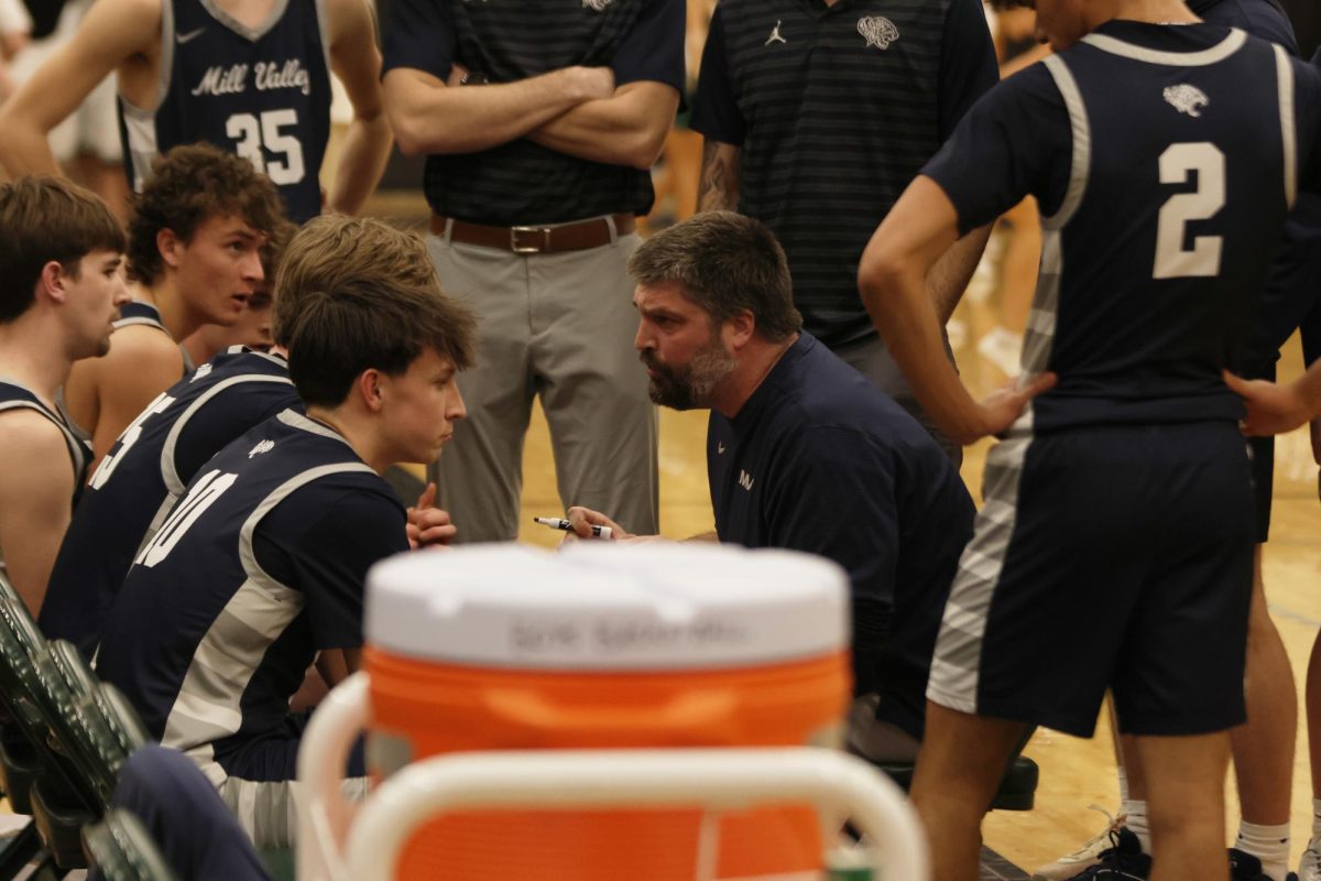 Coach Kurtis Bangle explains the game plan to his players during a time out