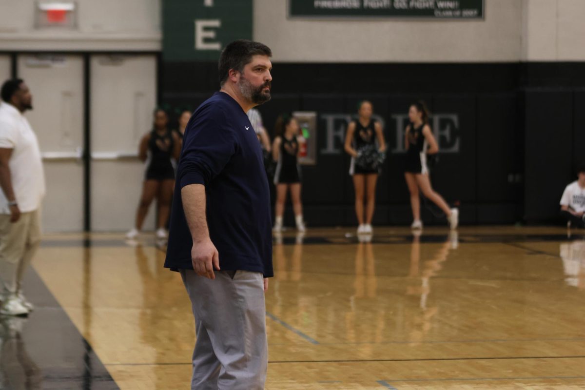 Coach Kurtis Bangle looks to his players down the court