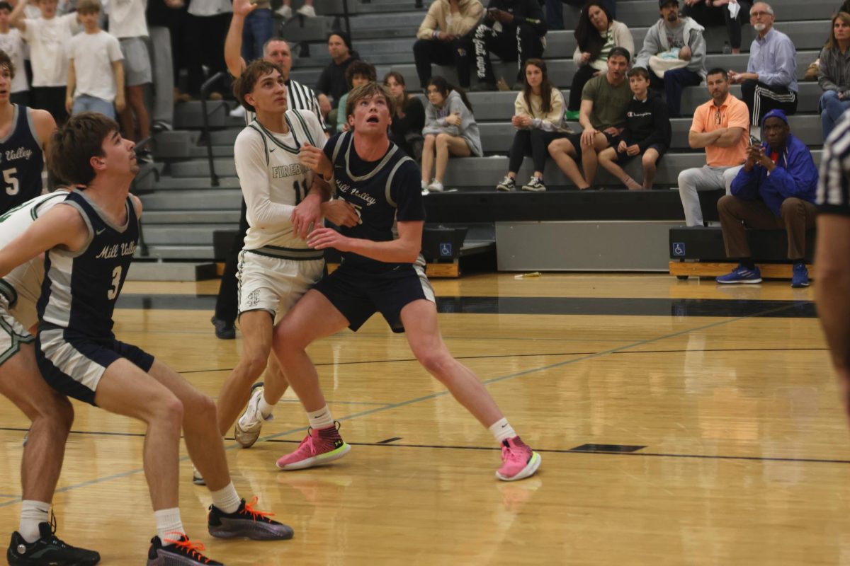 Senior Carter Kaifes boxes out an opponent while waiting for the rebound