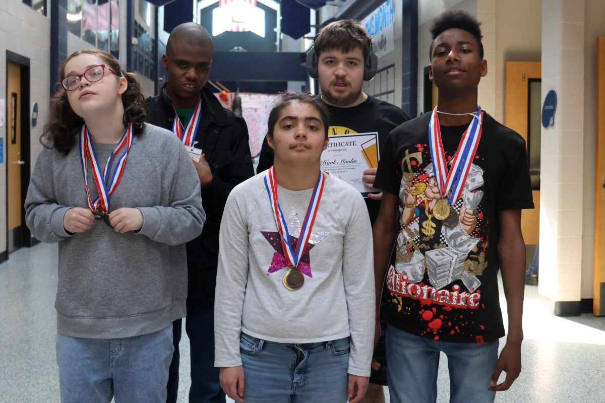 Senior Robyn Bishop, freshman Halee Alfaro, freshman Tyrese Davis, senior Adairius Newton and junior Henry Moulin pose with the awards that they won.  