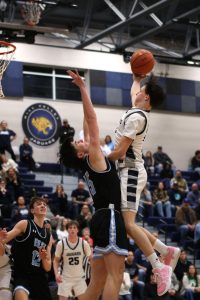 In the air, junior Jack Carpenter shoots the ball. 