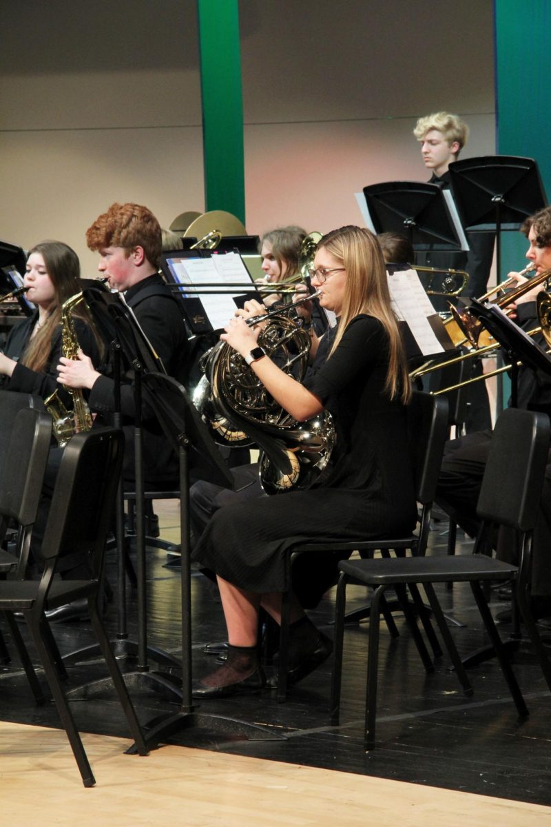 Looking ahead, junior Jamie Boggs looks at her music while she plays along. 