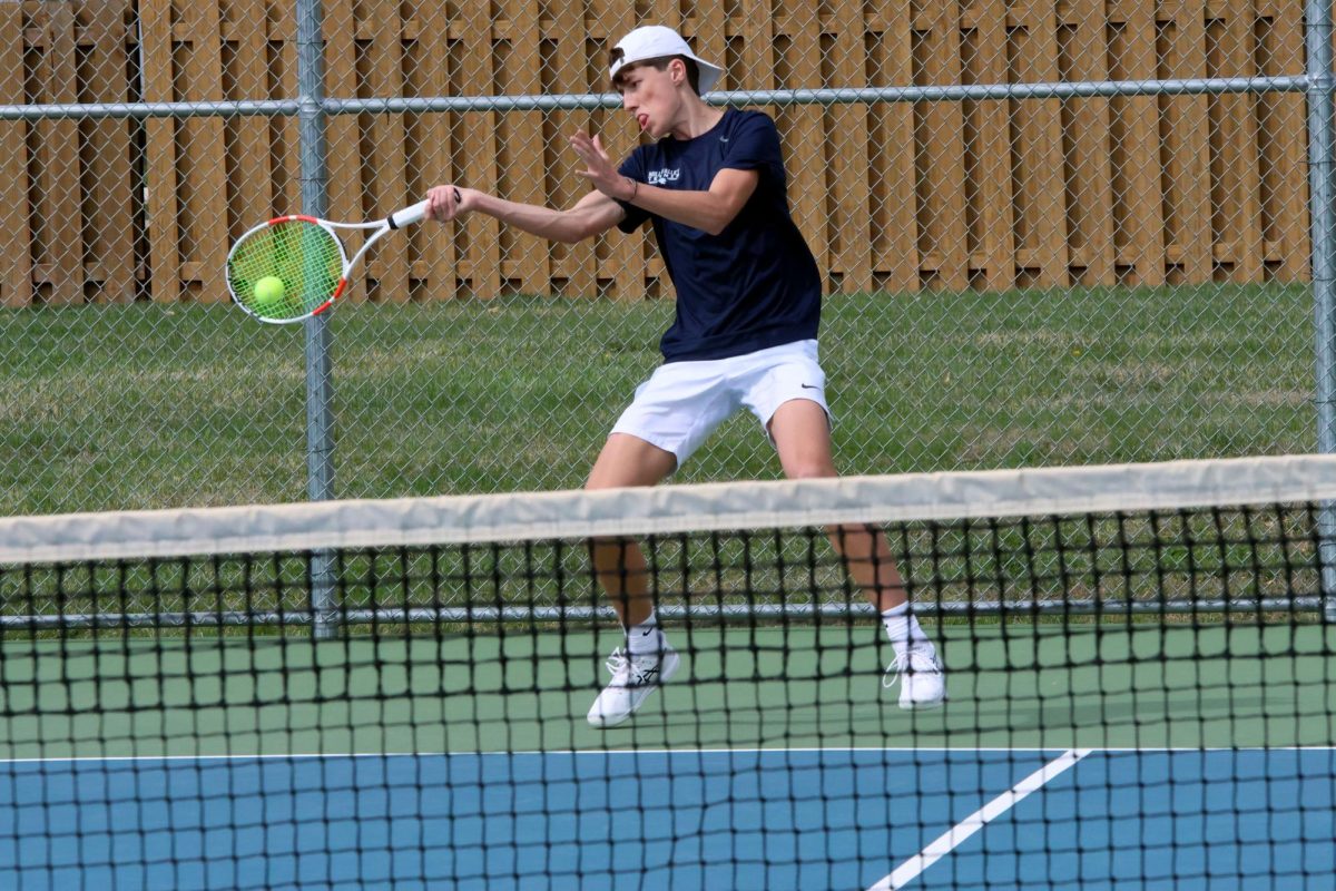 Sophomore Jace Hutchens returns a ball to his opponents.  